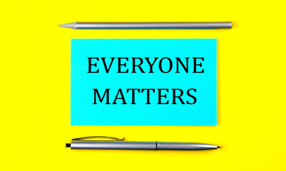 text EVERYONE MATTERS on the blue sticker on the yellow background
