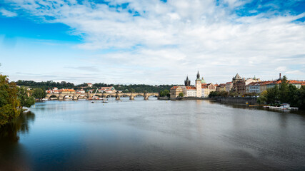 Fototapeta na wymiar Prague, Czech Republic. A view over the Vlatava River with the landmark Charles Bridge and Old Town Bridge Tower visible in the distance.