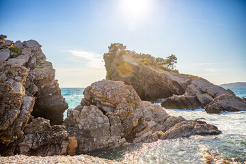 The beach and the cliffs on the island of St. Nicholas in Budva, Montenegro. Paradise beach on an island in the sea