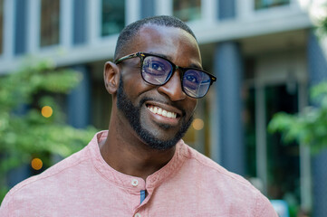 Outdoor portrait of smiling man wearing glasses