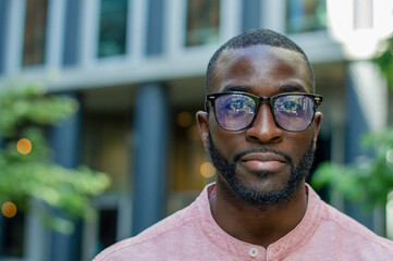 Outdoor portrait of serious man wearing glasses