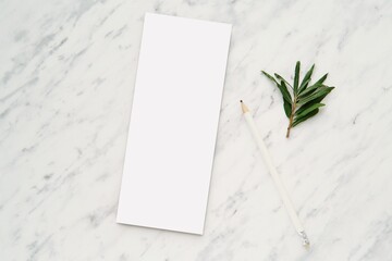 Skinny notepad mockup on marble background, notebook, memo pad, list mock up for design presentation, white pencil, top view.