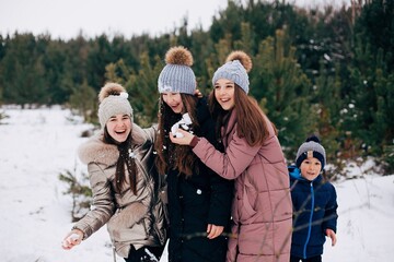 girl rubs her face with snow. snowball game