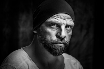 Grayscale of a Caucasian man feircely looking at the camera with a serious face