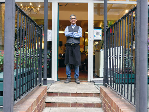 Portrait of cafe owner in doorway