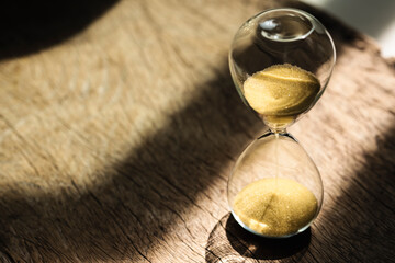 Sand clock , Hourglass as time passing on wooden background , Life time concept
