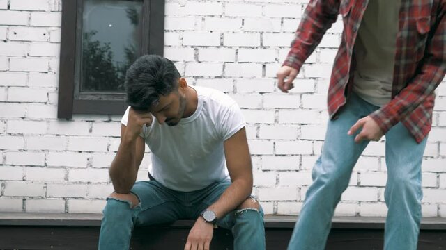 Male friend trying to support another upset depressed lonely young man friend. Male friendship. Male depression anxiety problems. Mental health problems. Friend's support 