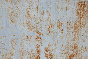 The White metal sheet surface has rust stains dark orange and Brown Color.
