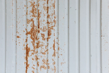 The White metal sheet surface has rust stains dark orange and Brown Color.