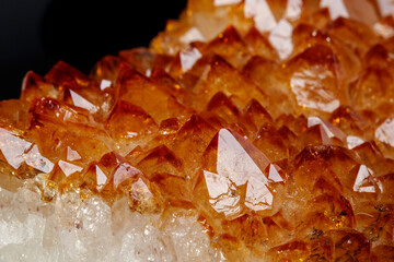 Macro mineral stone Citrine in rock in crystals on a black background