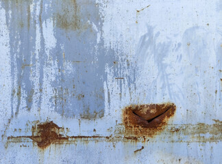 The texture of a light colored hard sheet with rust