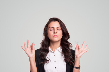 Businesswoman meditating with mudra gesture