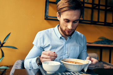 Fototapeta na wymiar Man eating soup lunch snack in a restaurant