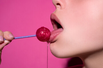 Close up profile, model licking a red lollipop - obrazy, fototapety, plakaty