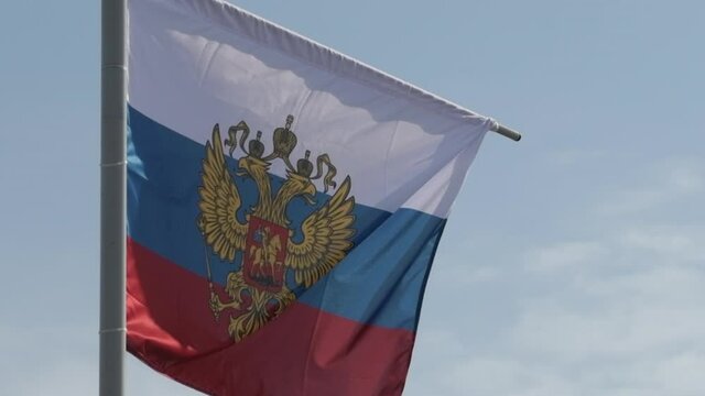 Russian flag with the coat of arms, two-headed eagle without the shield