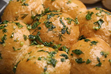 Traditional pampushka buns with garlic and herbs, closeup