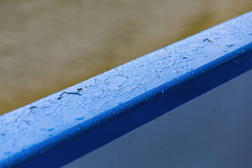 Bright blue surface with water drops and morning dew after rain