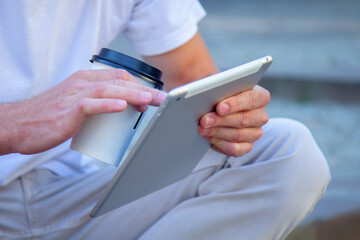 Young handsome man is using digital tablet.