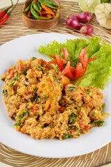 shrimp or prawn with salted egg sauce plated on a white plate and ingredients