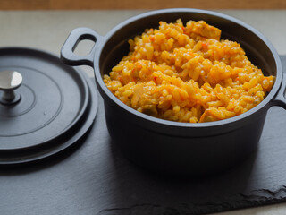 Paella - a Spanish dish originating in Valencia and occurring in many varieties. It is based primarily on rice with the addition of saffron, fried and cooked in a metal pan with two handles.