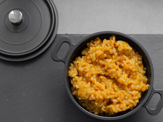 Paella - a Spanish dish originating in Valencia and occurring in many varieties. It is based primarily on rice with the addition of saffron, fried and cooked in a metal pan with two handles.