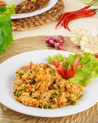 shrimp or prawn with salted egg sauce plated on a white plate and ingredients