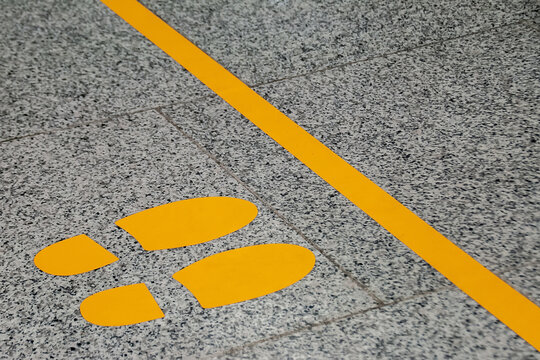 boundary yellow line with a pointer where to stand