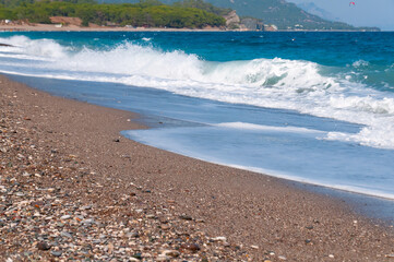 beautiful surf waves near the sandy beach on a clear summer da?