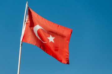 waving flag of Turkey against a blue sky