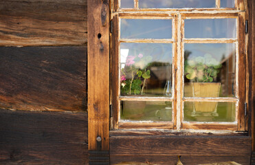 window with flowerpot of old wooden house