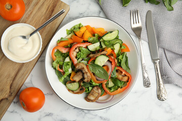 Delicious salad and bowl of mayonnaise on white marble table, flat lay