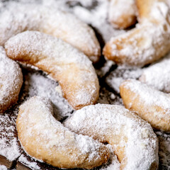 Fototapeta na wymiar Christmas shortcrust cookies vanilla crescents with icing sugar. Top view