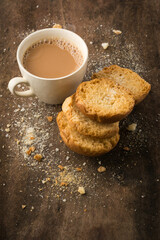 butter biscuits and a cup of tea, served on a wooden table top, teatime snack closeup view with copy space