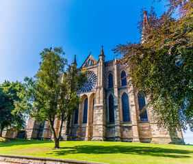 Fototapeta premium A view through trees towards the cathedral in Durham, UK in summertime