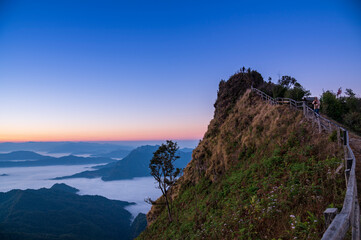 Fototapeta na wymiar Sunrise or Sunset Landscape of the mountain and sea of mist in winter sunrise view from top of Doi Pha Tang mountain , Chiang Rai, Thailand 