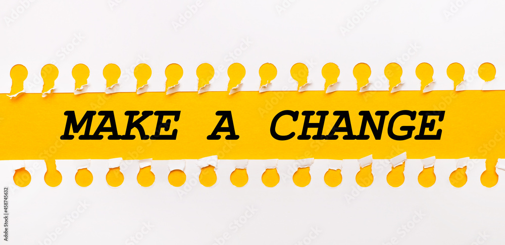 Aufkleber torn paper strip on yellow background with text make a change