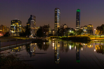 Fototapeta na wymiar Night view to skyscrapers of Santiago de Chile reflected in the water