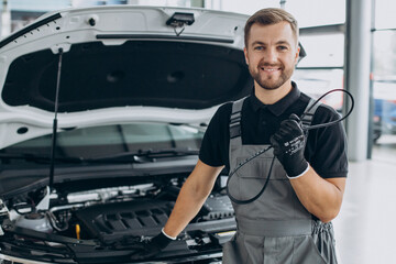 Car mechanic checking up a car at a car service