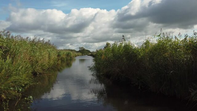 Nature scenery at the Weerribben-Wieden National Park in Overijssel the Netherlands, POV sailing through reed