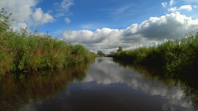 Nature scenery at the Weerribben-Wieden National Park in Overijssel the Netherlands, POV sailing through reed