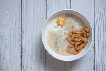 Thai pork congee or porridge topping with boiled egg and mini dough