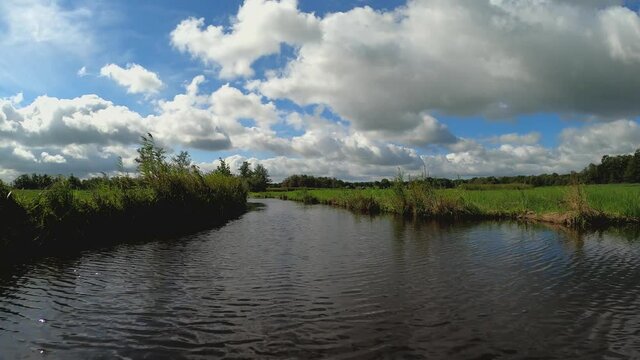 Nature scenery at the Weerribben-Wieden National Park in Overijssel the Netherlands, POV sailing through reed and quiver