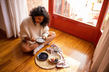 Woman eating healthy berries with chia seeds for breakfast