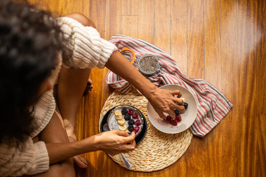 Woman eating healthy berries with chia seeds for breakfast