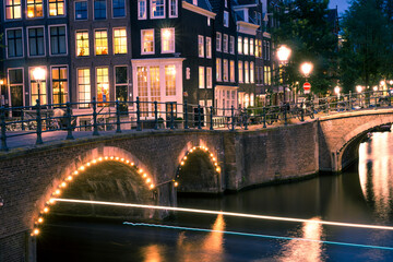 Amsterdam bridge over canal at night