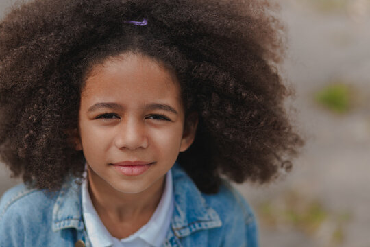 Lovely girl with bright smile and beautiful curly hair