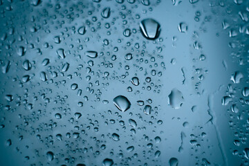 water droplets on glass. close-up. macro plan. blue background.