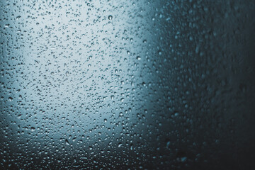 water droplets on glass. close-up. macro plan. blue background.