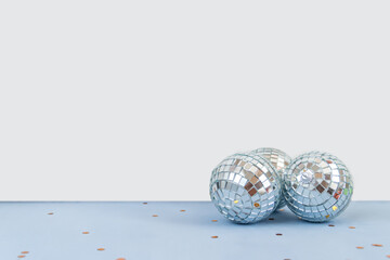 Disco ball against white and light blue background with empty space for text 

