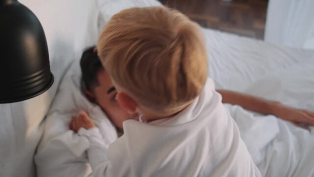 A father spending time with his son at the bedroom at home